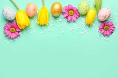 Composition with painted Easter eggs, beautiful flowers and confetti on color background