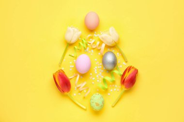 Composition with Easter eggs, beautiful tulip flowers and confetti on color background