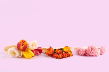 Tortillas with beautiful flowers on pink background