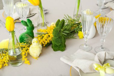 Festive table setting with baby chickens and bunnies for Easter celebration