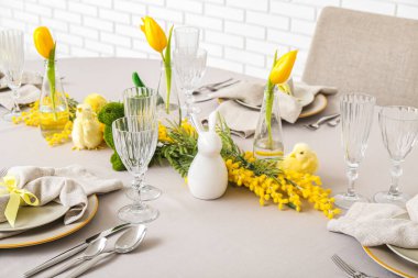 Festive table setting with baby chicken and bunny for Easter celebration