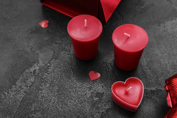 Red candles on dark background, closeup. Valentine\'s Day celebration