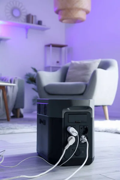 Portable power station charging devices on floor in living room