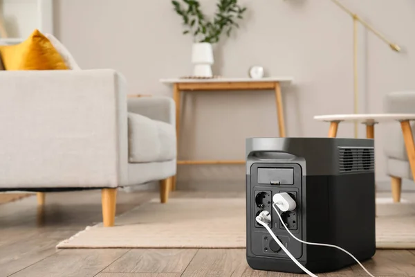 Portable power station charging devices on floor in living room