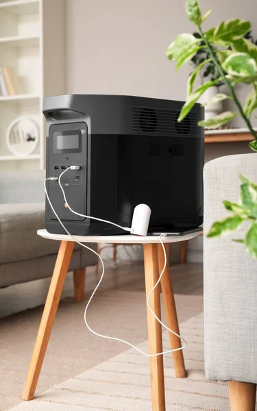 Portable power station charging devices on table in living room