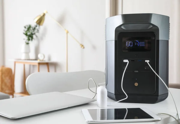 Portable power station charging devices on table in office