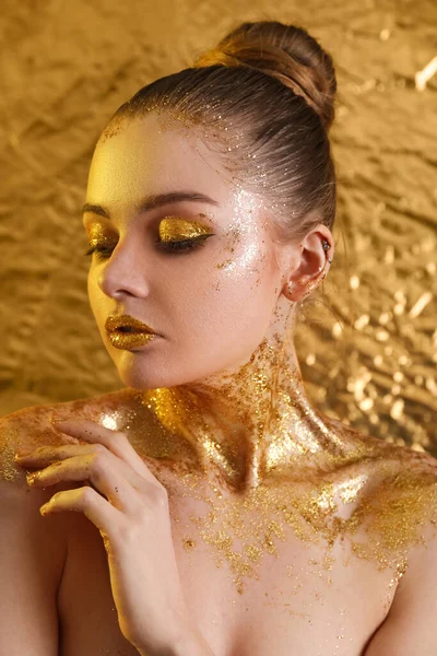 Young Woman Golden Glitter Makeup Yellow Foil Background Closeup — 스톡 사진