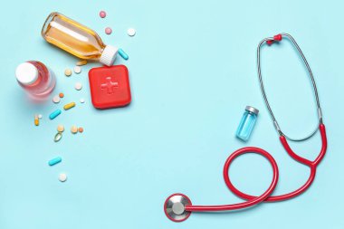 Frame made of medications and stethoscope on blue background. World Health Day