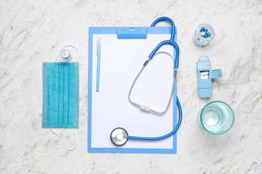Blank clipboard with medical supplies on grunge background. World Health Day