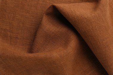 Closeup view of crumpled brown fabric as background