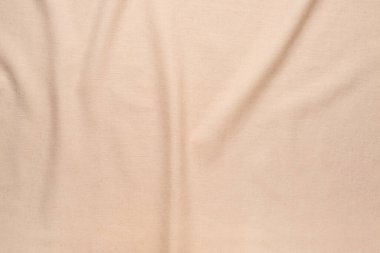 Closeup view of crumpled beige fabric as background