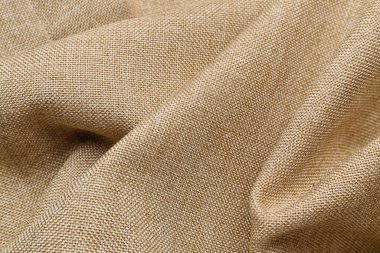Closeup view of crumpled beige fabric as background