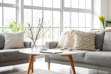 Grey sofas with stylish cushions in interior of living room