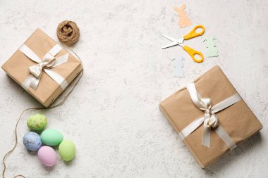 Frame made of gifts, Easter eggs, scissors and rope on grunge background