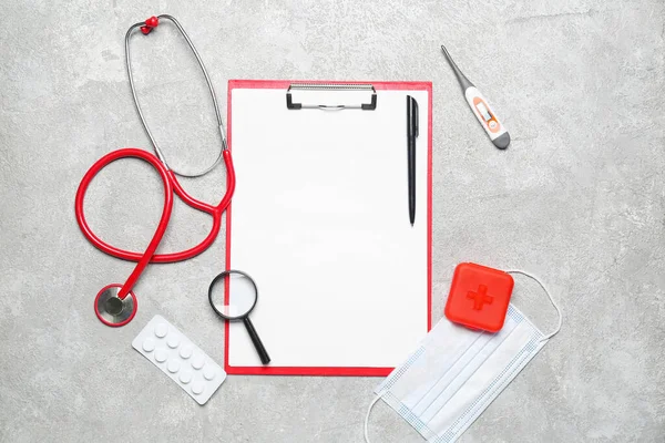 Blank clipboard with medical supplies on grunge background. World Health Day