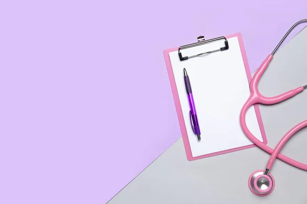 Blank clipboard with pen and stethoscope on color background. World Health Day
