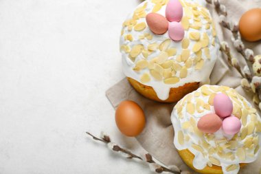 Easter cakes, painted eggs and pussy willow branches on white background