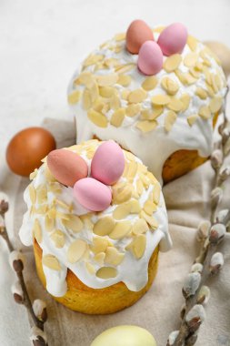 Easter cakes, painted eggs and pussy willow branches on white background
