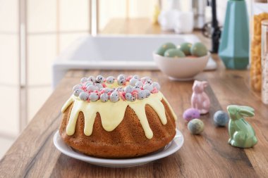 Easter cake with painted eggs and bunnies on kitchen counter