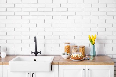 Easter cake with painted eggs on kitchen counter