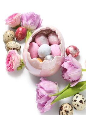 Easter eggs and beautiful flowers on white background
