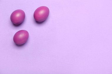 Dyed Easter eggs on lilac background