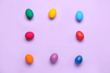 Colorful Easter eggs on lilac background
