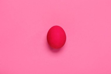 Painted Easter egg on pink background