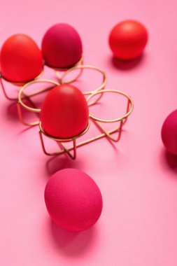 Dyed Easter eggs on pink background