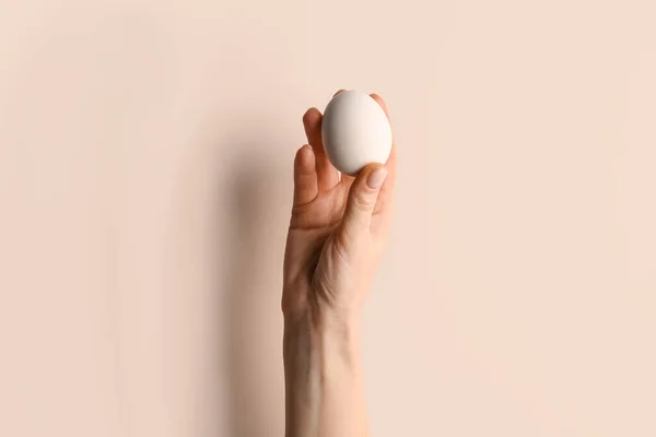 Woman Holding Egg Beige Background — Stok fotoğraf