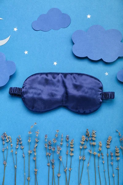 Composition with sleeping mask, lavender flowers and paper decor on color background. World Sleep Day concept