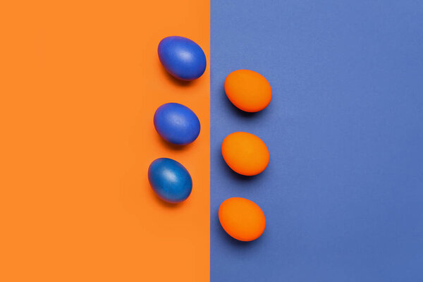 Painted Easter eggs on blue and orange background