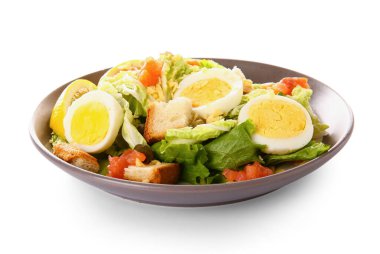 Plate of delicious salad with boiled eggs and salmon isolated on white background