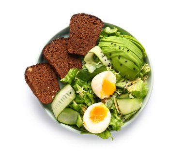 Plate of delicious salad with boiled eggs and avocado isolated on white background