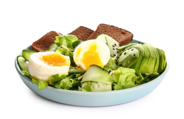 Plate of delicious salad with boiled eggs and avocado isolated on white background