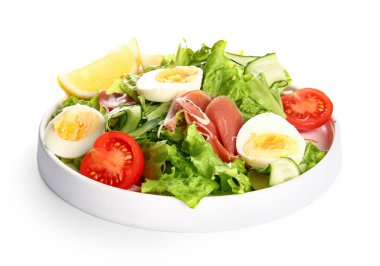 Plate of delicious salad with boiled eggs and jamon isolated on white background
