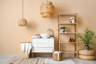 Interior of bathroom with sink, drawers and shelving unit