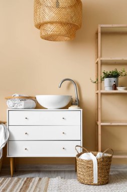 Interior of bathroom with sink, drawers and shelving unit