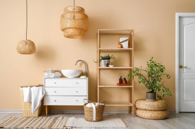Interior of bathroom with sink, drawers and shelving unit