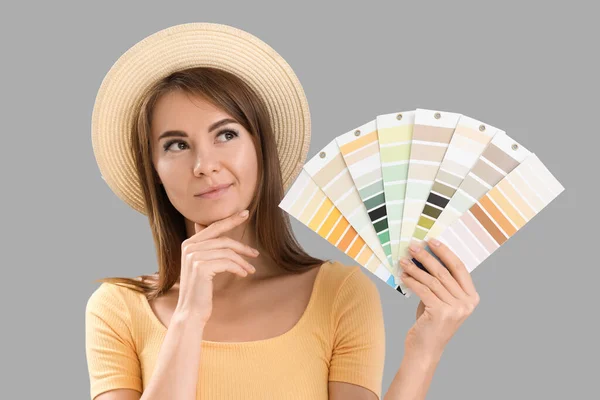 Thoughtful Young Woman Paint Color Palettes Grey Background — Stock Photo, Image