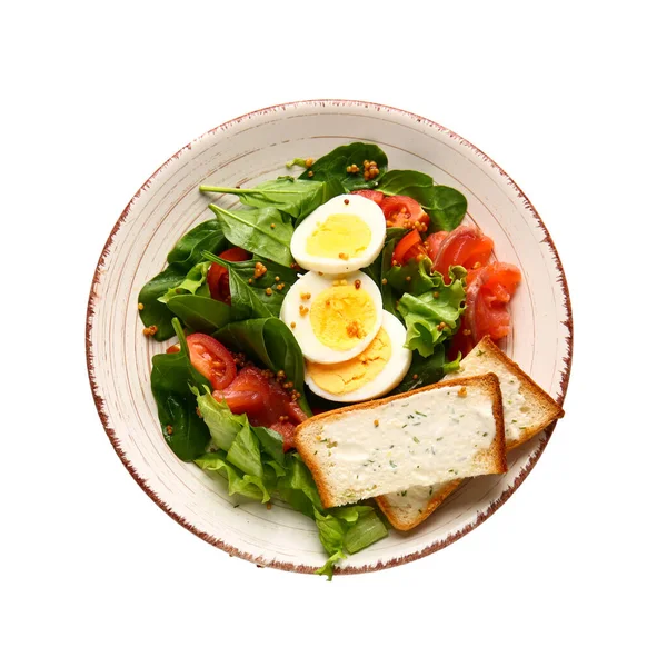 Plate of delicious salad with boiled eggs and salmon isolated on white background