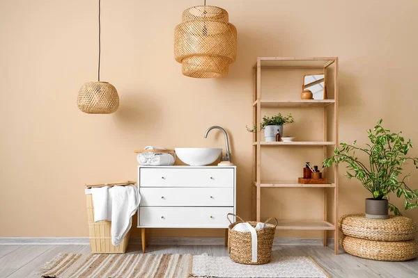 Interior of bathroom with sink, drawers and shelving unit