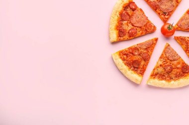 Slices of delicious pepperoni pizza and cherry tomato on pink background