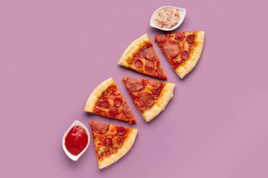 Composition with slices of delicious pepperoni pizza on lilac background