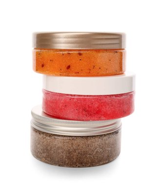 Jars with natural body scrub on white background