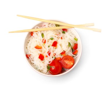 Bowl of tasty rice noodles with vegetables on white background
