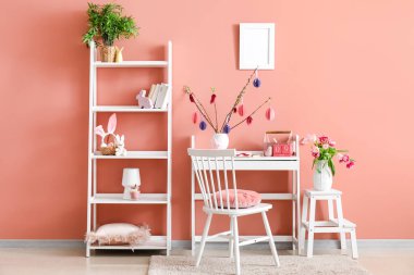 Stylish interior of room with Easter decor and tulip flowers