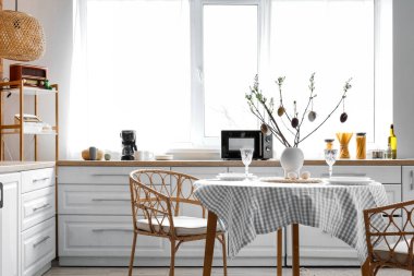 Interior of kitchen with Easter decor, counters and dining table