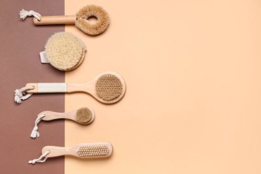 Set of different massage brushes on color background