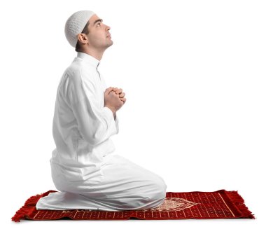 Praying Muslim man on white background
